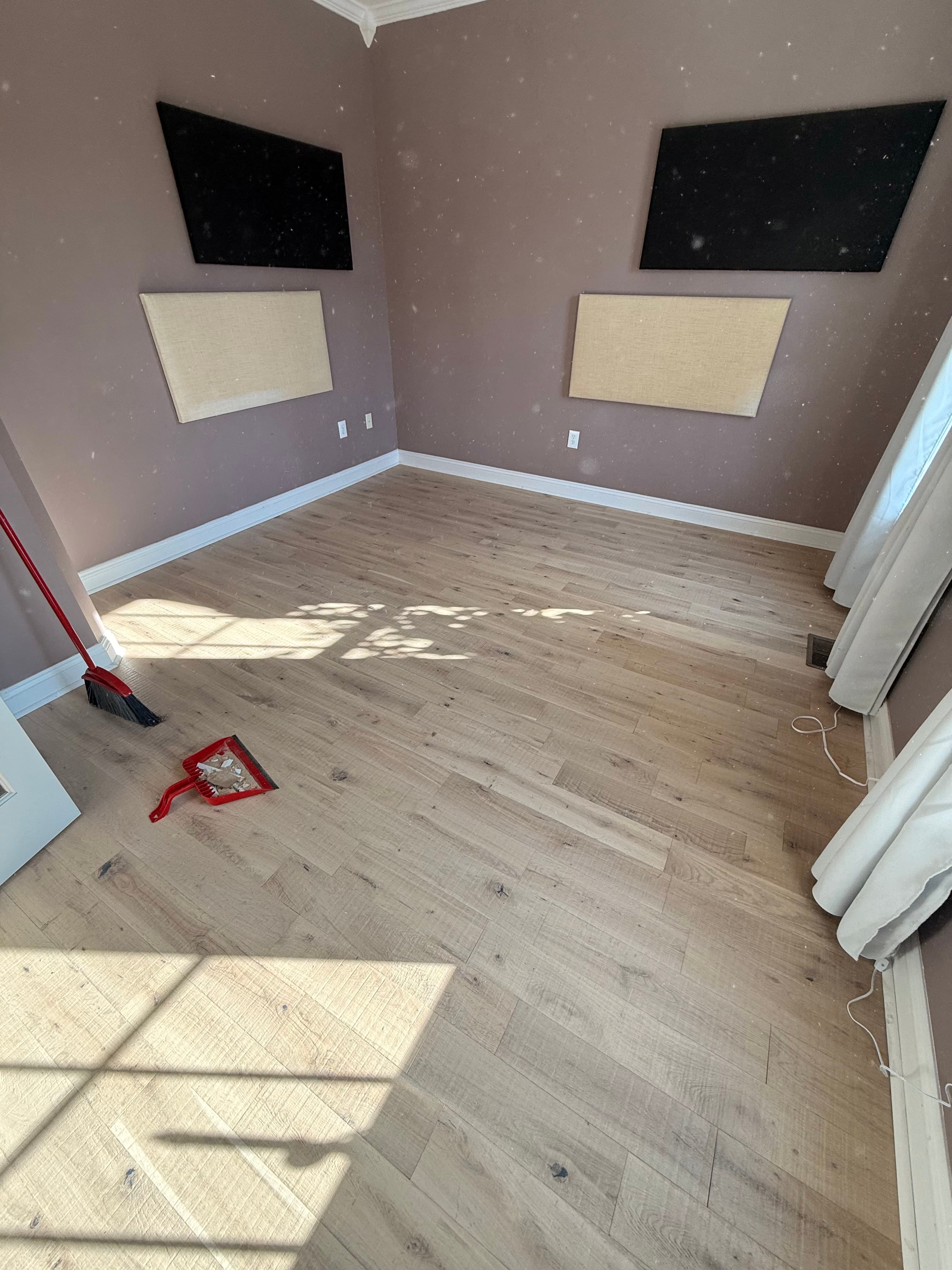 Complete room renovation with new flooring, paint, and trim work by TriCraft
